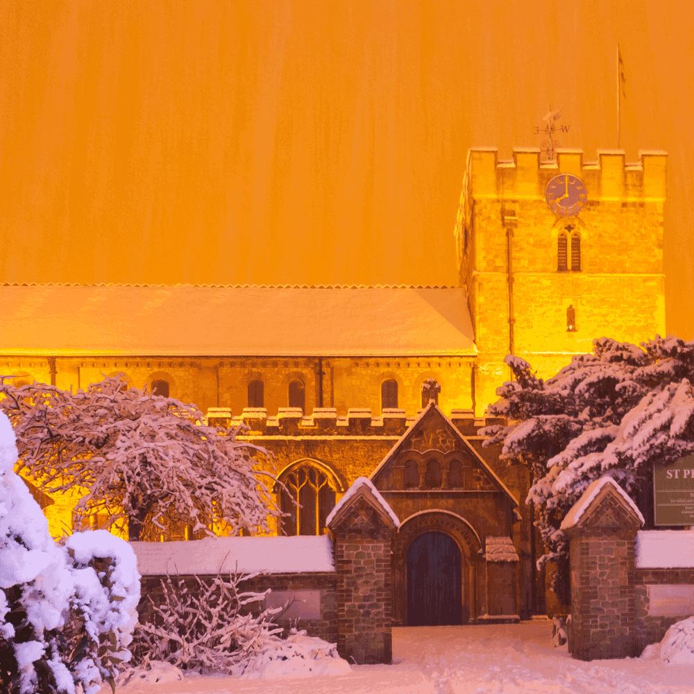 Church covered in snow at night