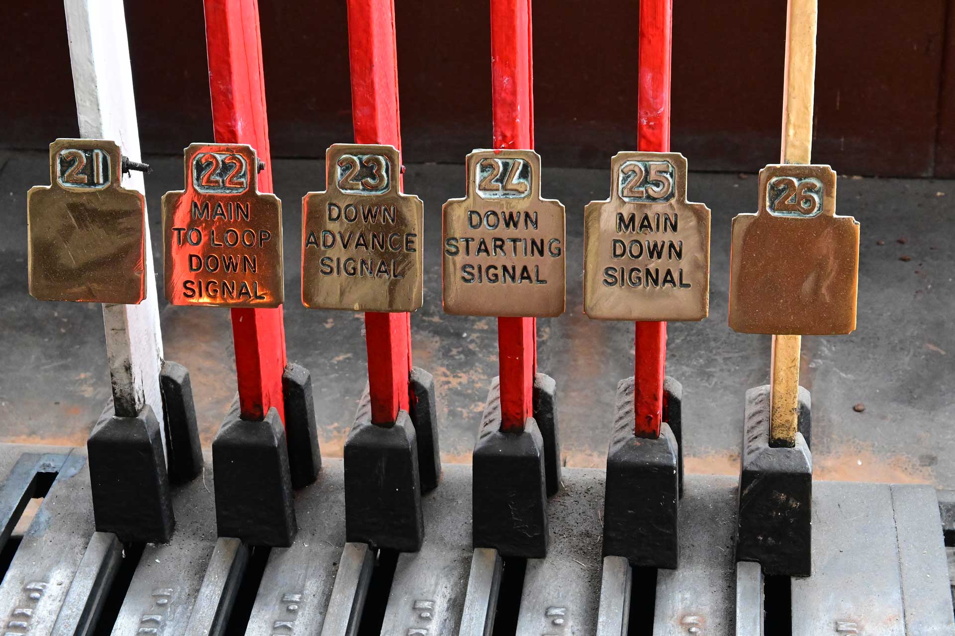 Six levers for controlling old railway signals.