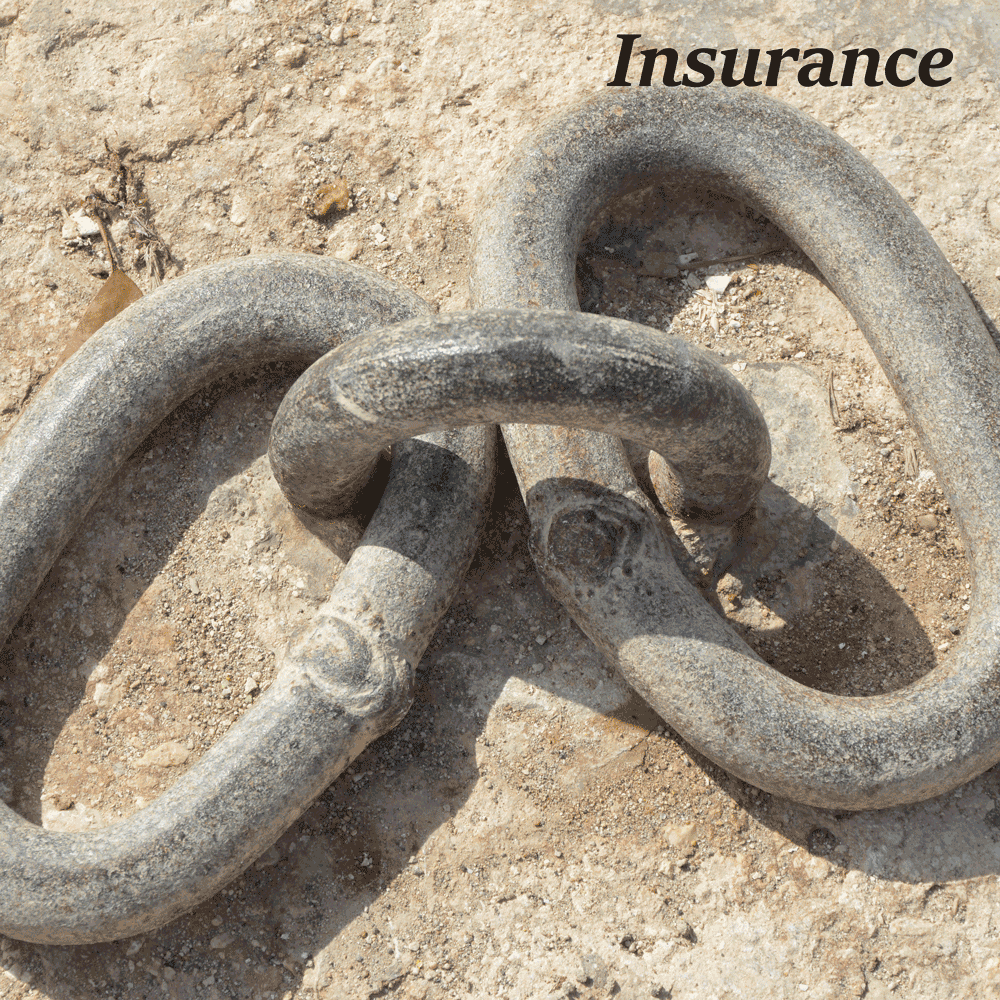 Two large chain links joined to a heavy duty eyelet set in concrete.